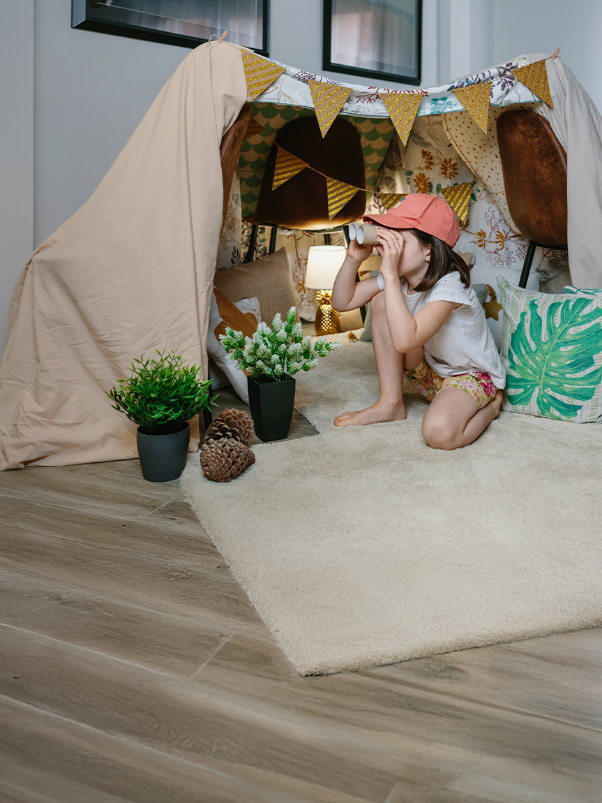 Child playing on hardwood floor.
